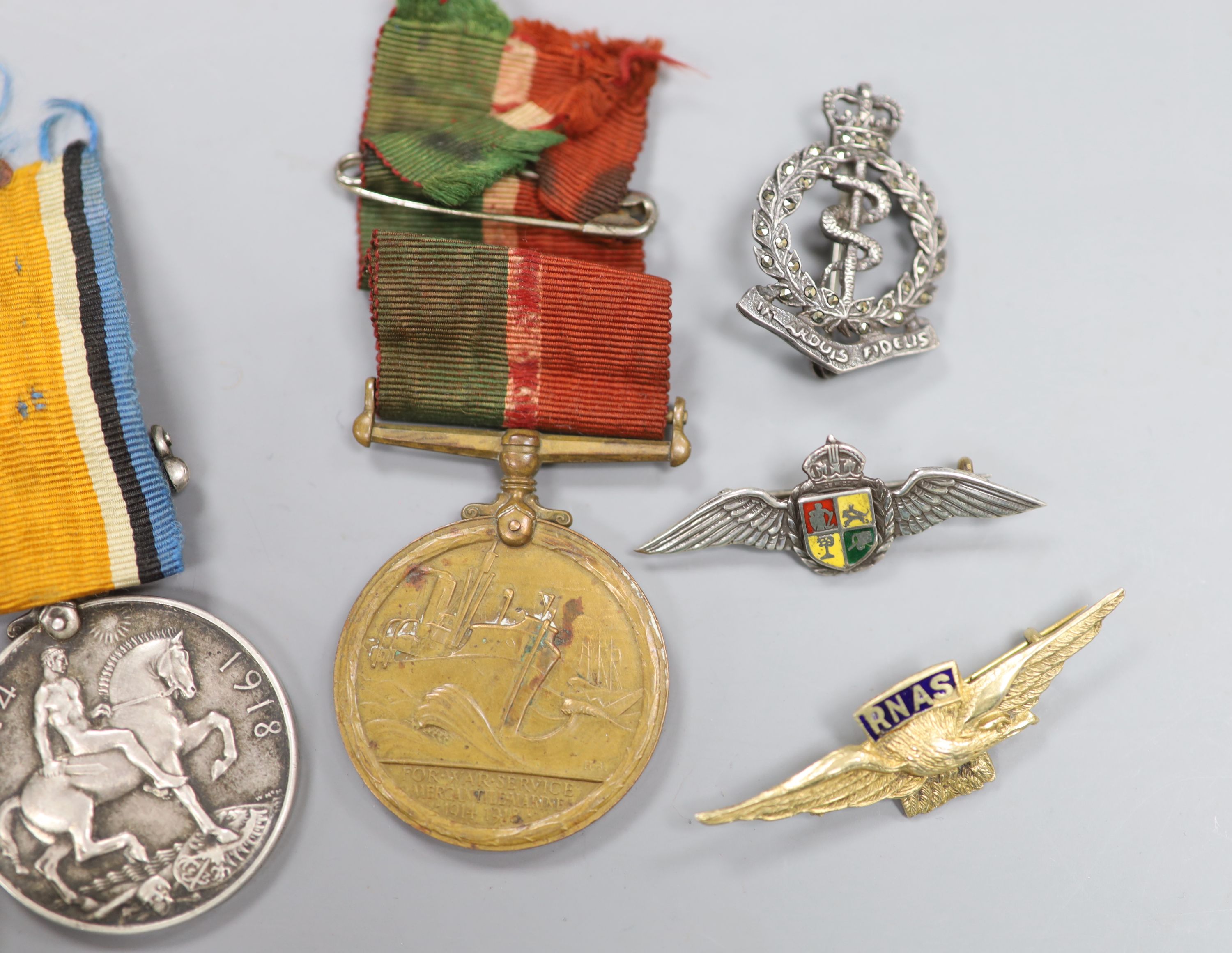 A WWI compass and two medals, together with lapel badges, etc.